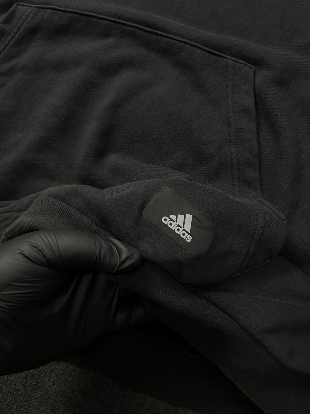 Adidas Future Icons Hoodie in black with an orange logo