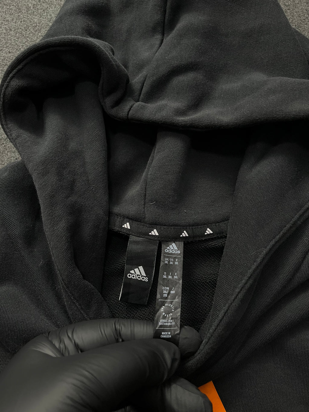 Adidas Future Icons Hoodie in black with an orange logo