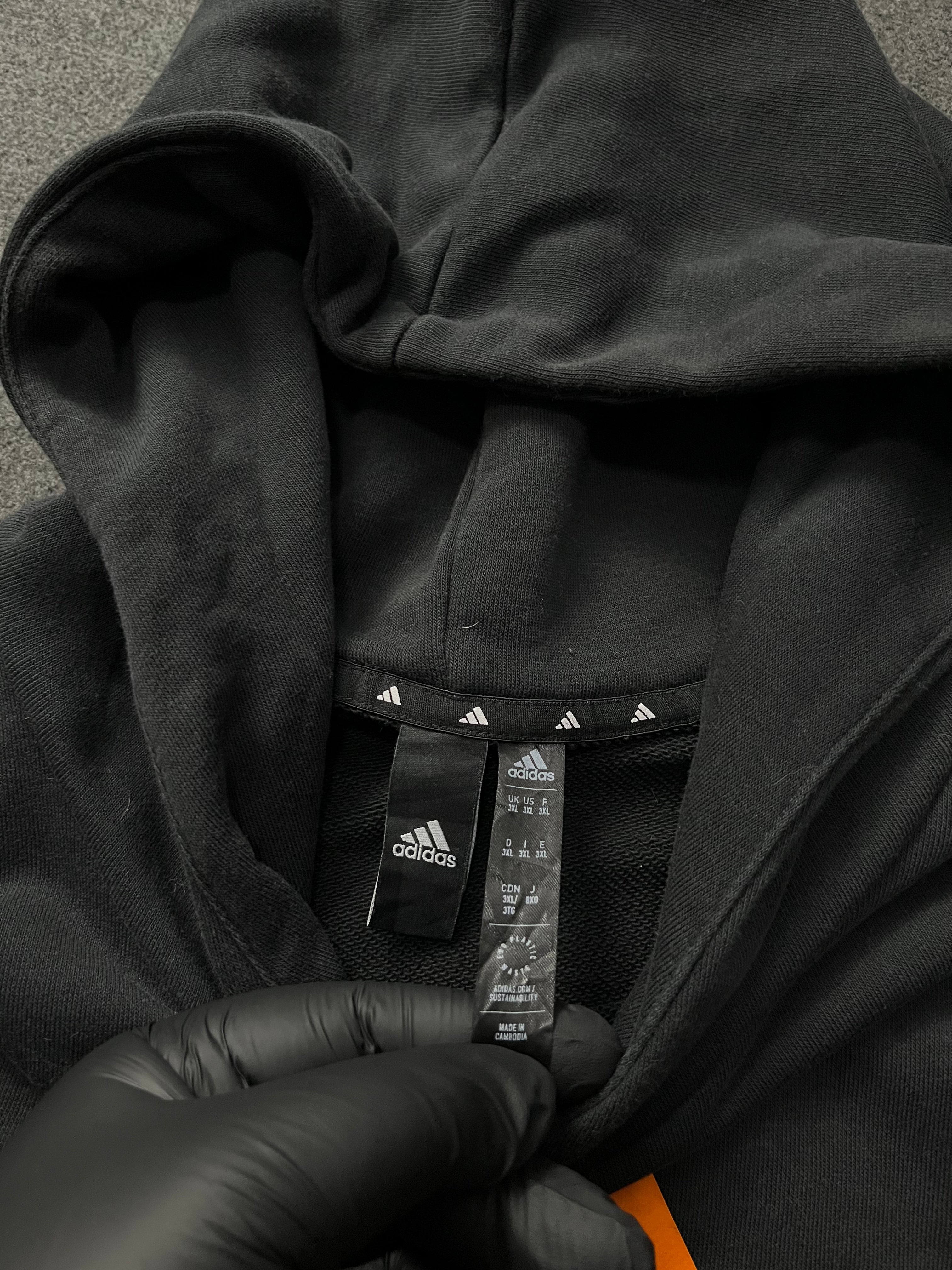 Adidas Future Icons Hoodie in black with an orange logo