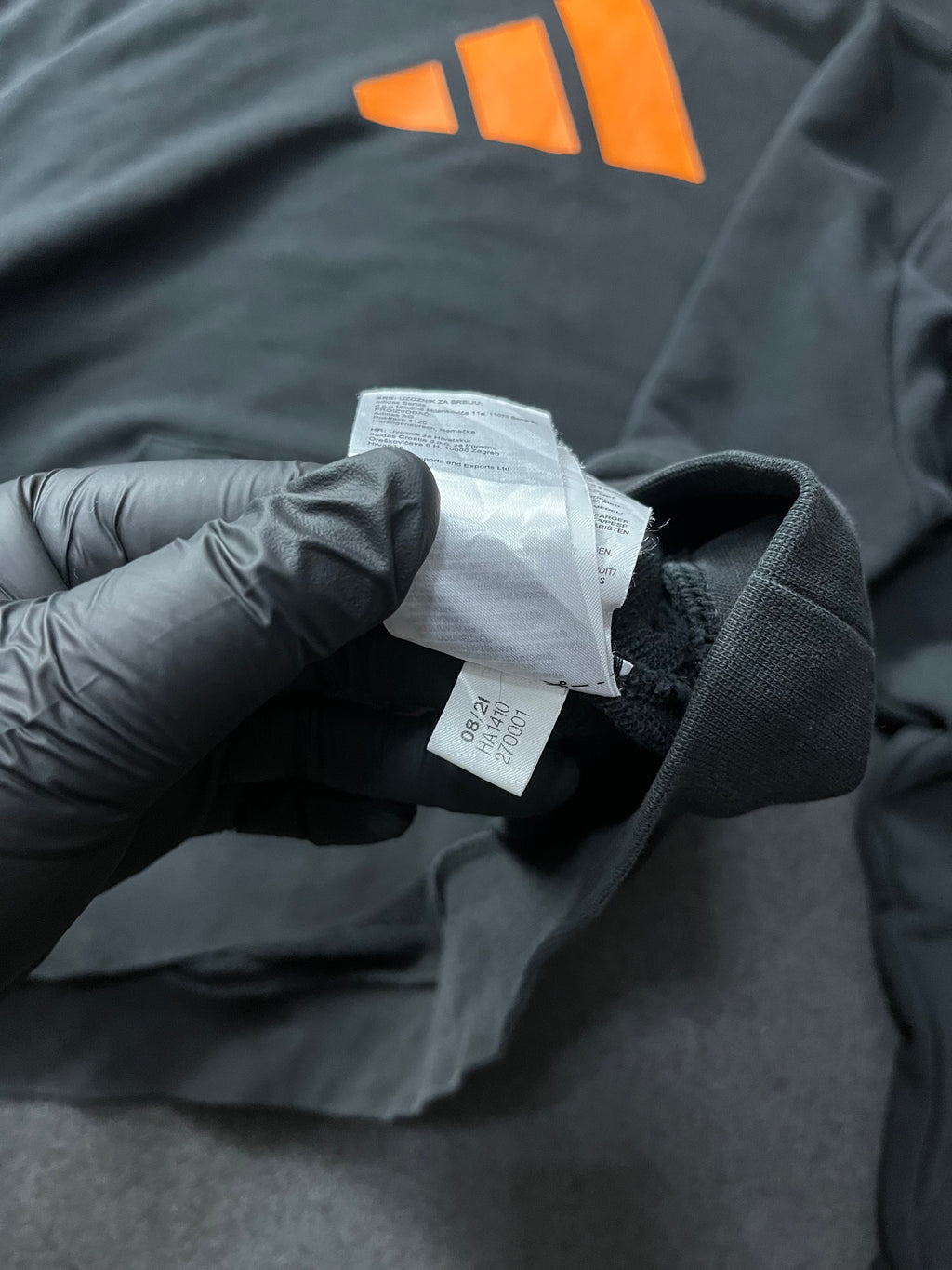 Adidas Future Icons Hoodie in black with an orange logo