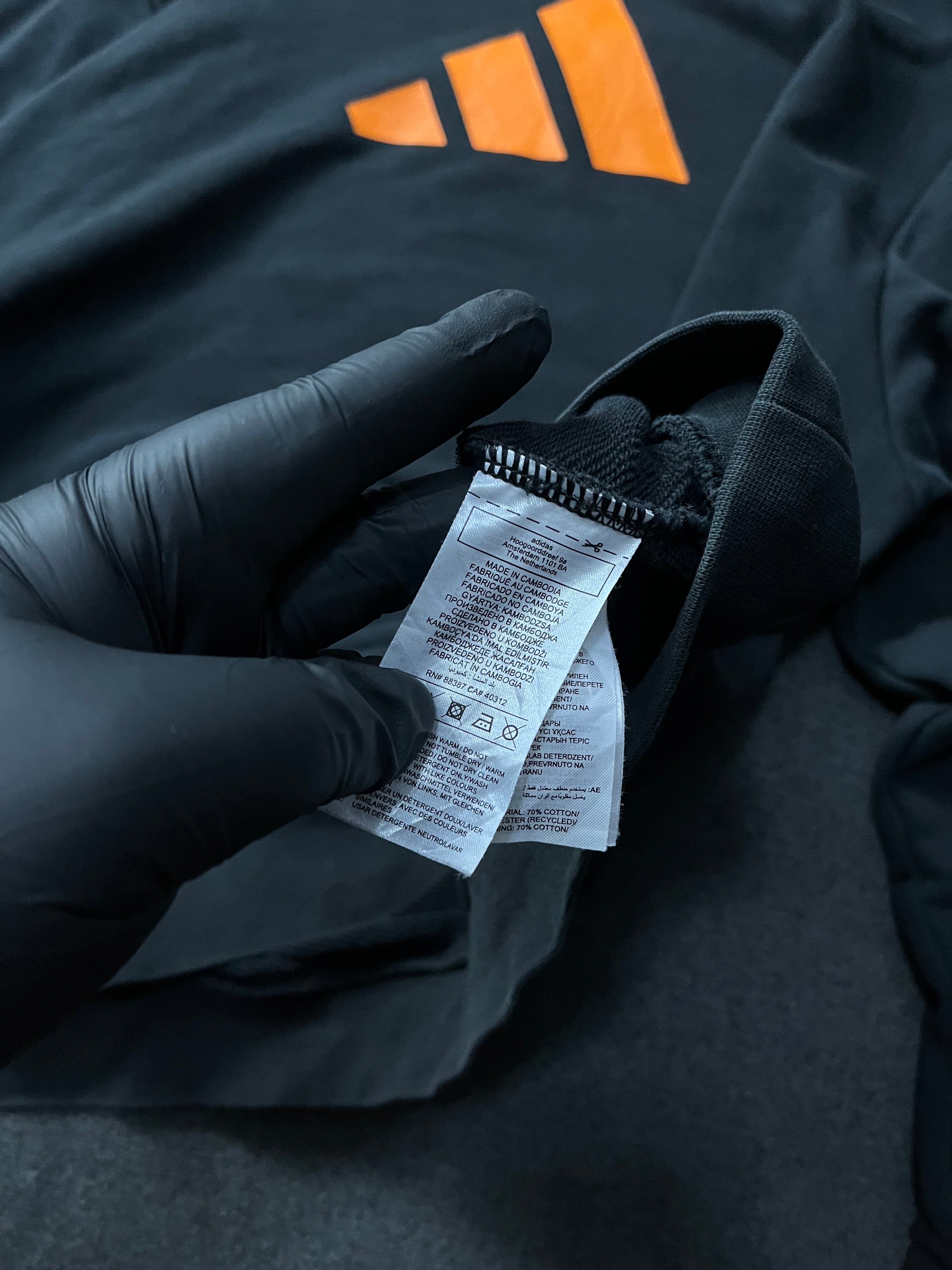 Adidas Future Icons Hoodie in black with an orange logo