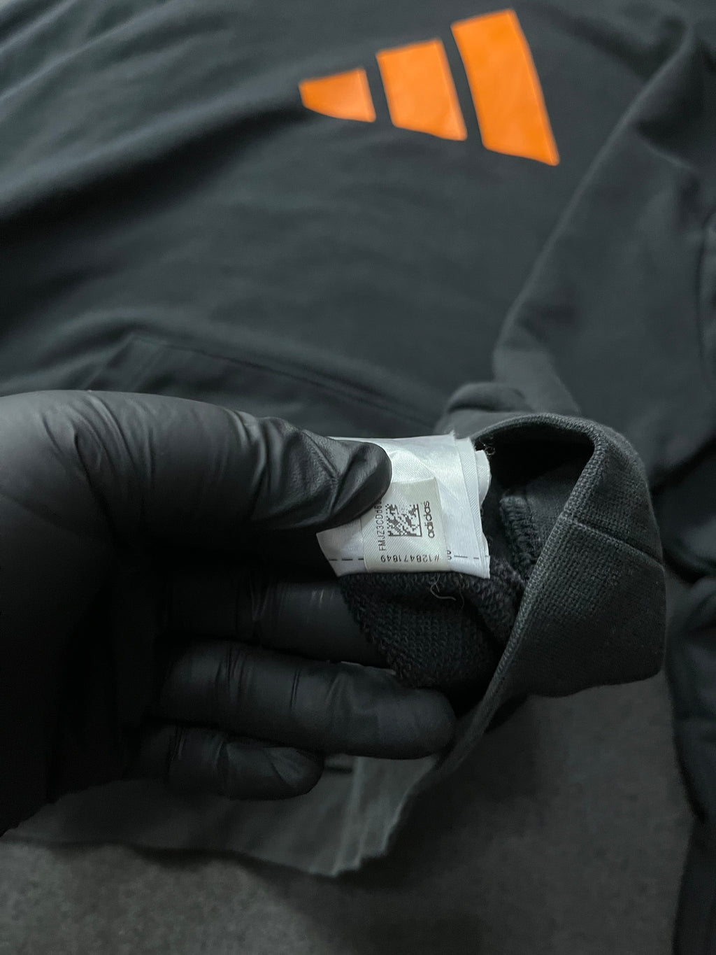 Adidas Future Icons Hoodie in black with an orange logo