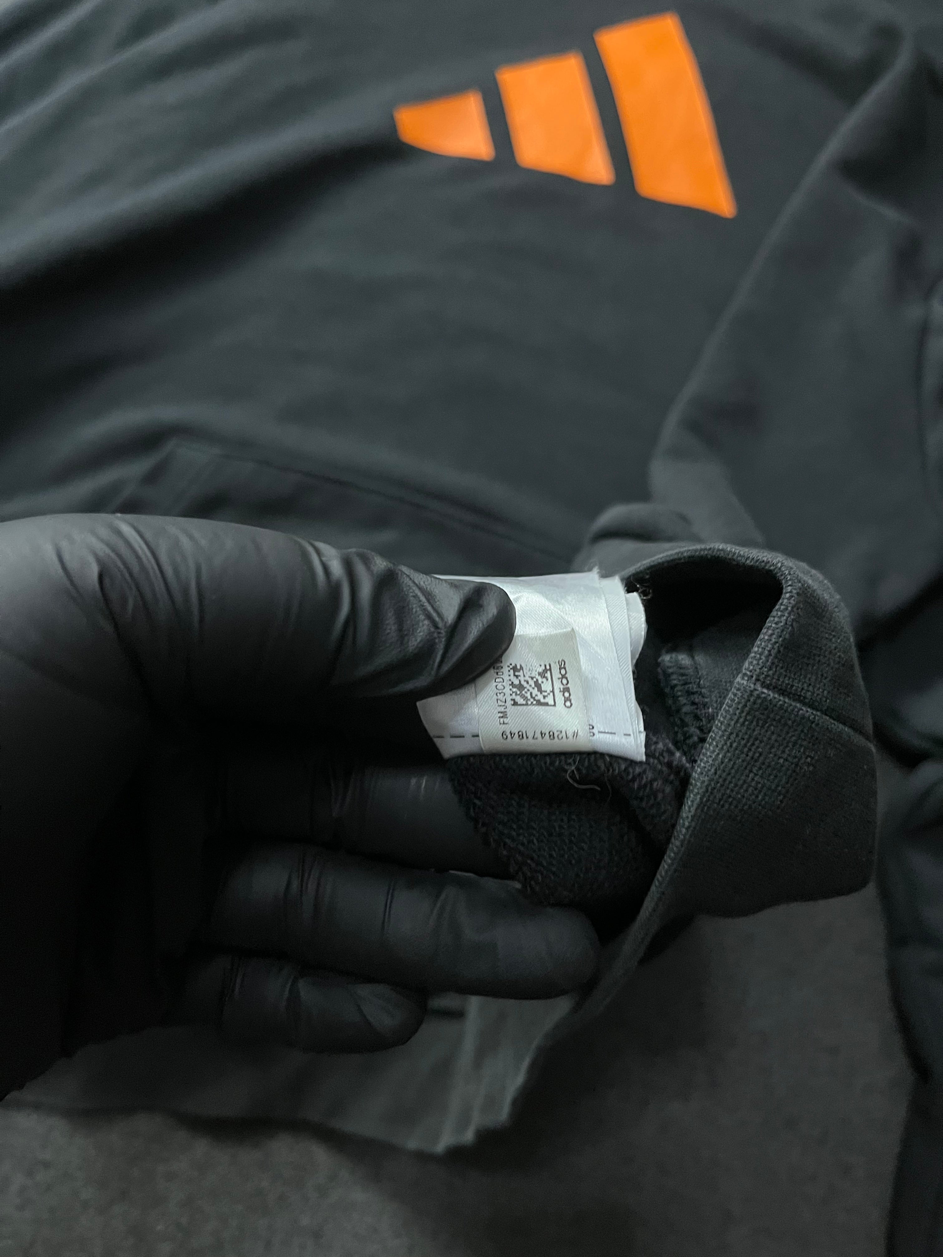 Adidas Future Icons Hoodie in black with an orange logo