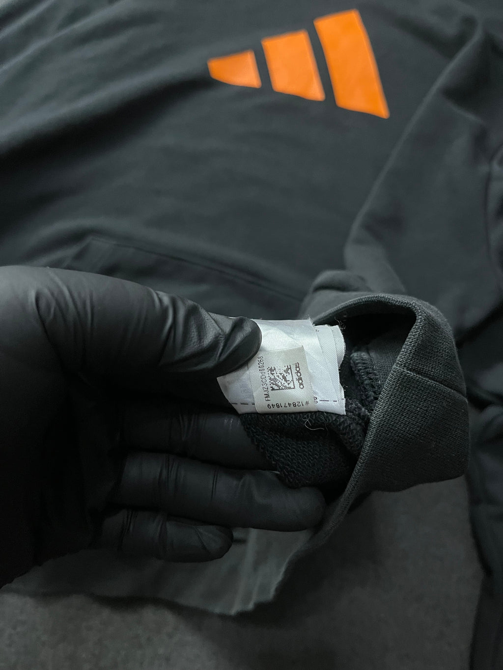 Adidas Future Icons Hoodie in black with an orange logo